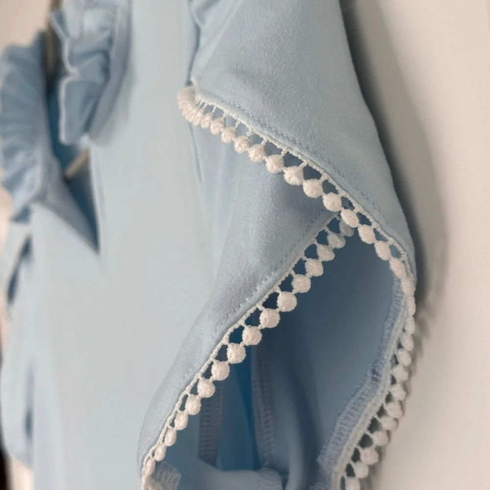 Sky Blue Ruffled Kids Blouse fits like a woman’s small
